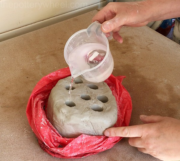 pouring water onto clay