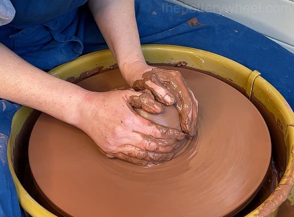 cupping hands to check clay is centered