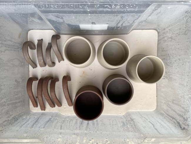 pots and handles in damp box