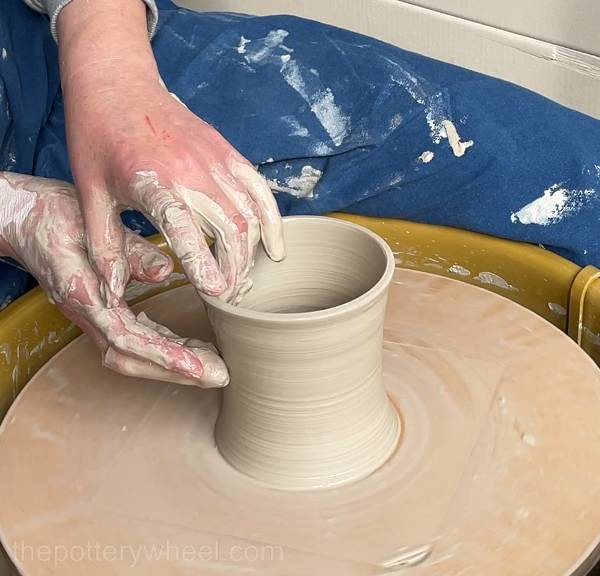 pulling the walls of the sculpd clay