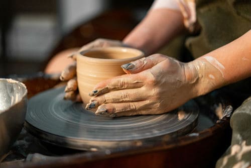 Hands working on pottery wheel. Sculptor, Potter. Human Hands