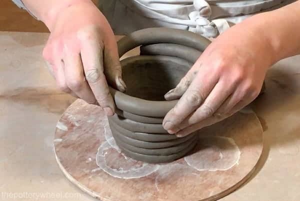 Premium Photo  Freshly made clay pot on a potters wheel