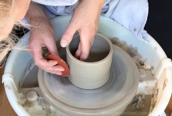 Making a clay pottery storage jar with lid on a potters wheel demo