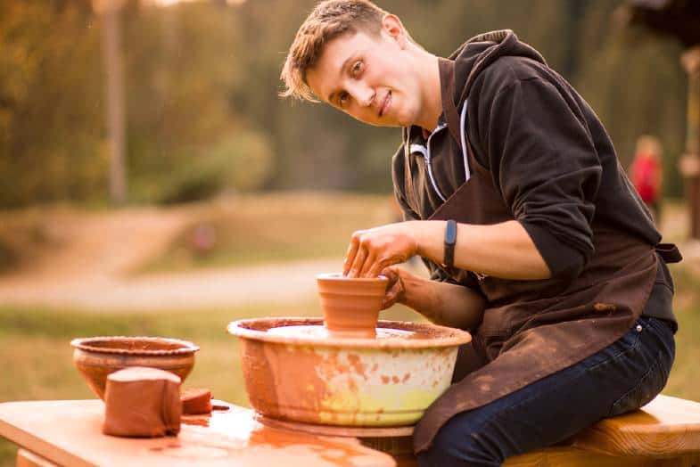 Potter at work at his pottery wheel 