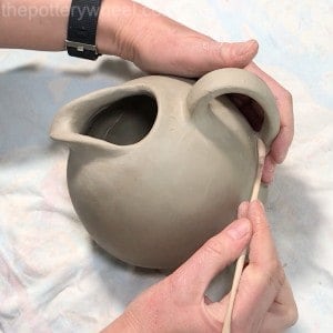 a handle on a double pinch pot