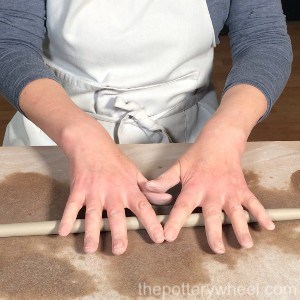rolling a coil of clay