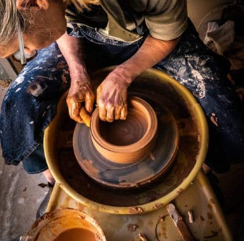 Potter at work at his pottery wheel 