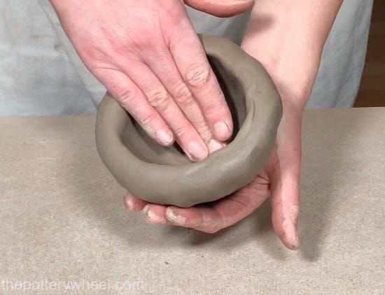smoothing the clay