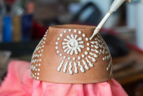decorating pottery with a slip trailer