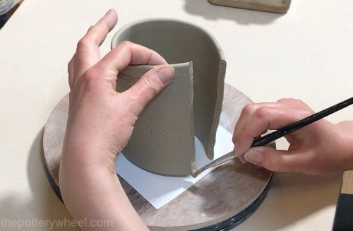 applying slip to seam of mug