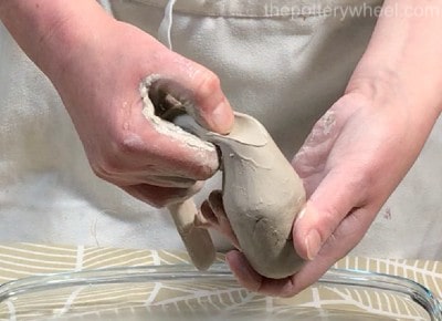 pinching the clay handle off