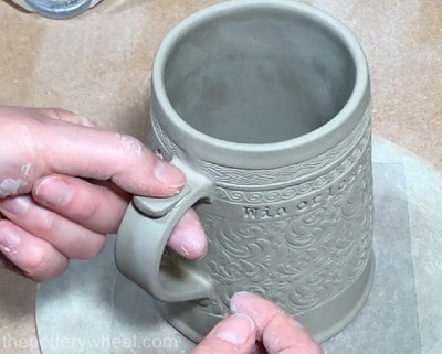 pressing thumb rest onto handle