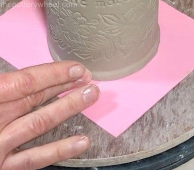 smoothing the base of slab built mug