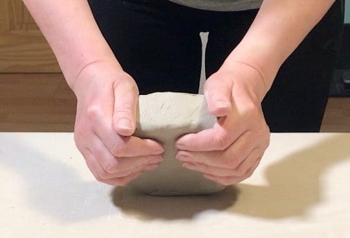 patting clay into shape