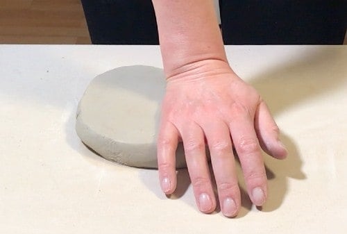 pressing clay with heel of hand