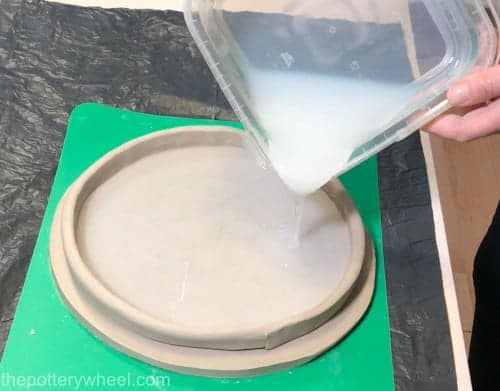 pouring the silicone onto the clay texture mat