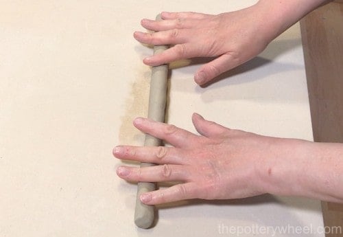 rolling out a coil of clay