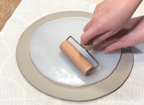 rolling the clay texture mat onto the slab