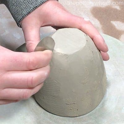 metal rib smoothing the clay