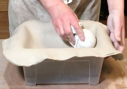 shaping the clay slab