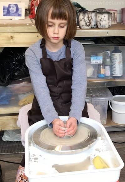 child using pottery wheel