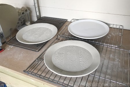 greenware pottery drying out on rack