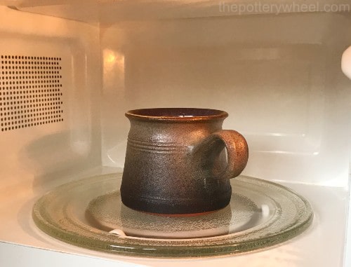 I feel like this is a good one. I put this ceramic mug in the microwave  sometimes and overtime this black sludge appears in the outside? What is it  and why do