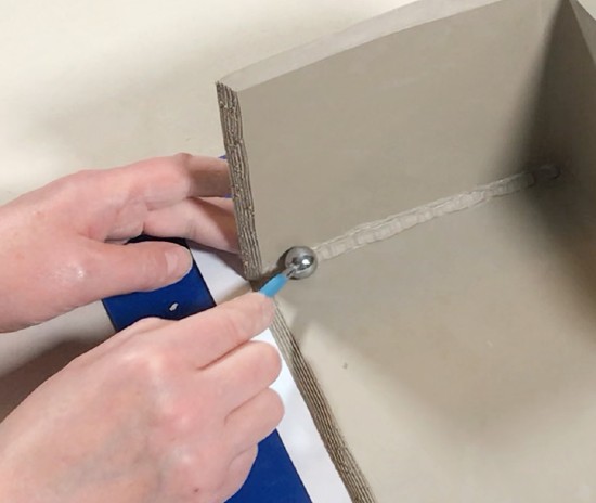 Adding a coil of clay with a stylus tool