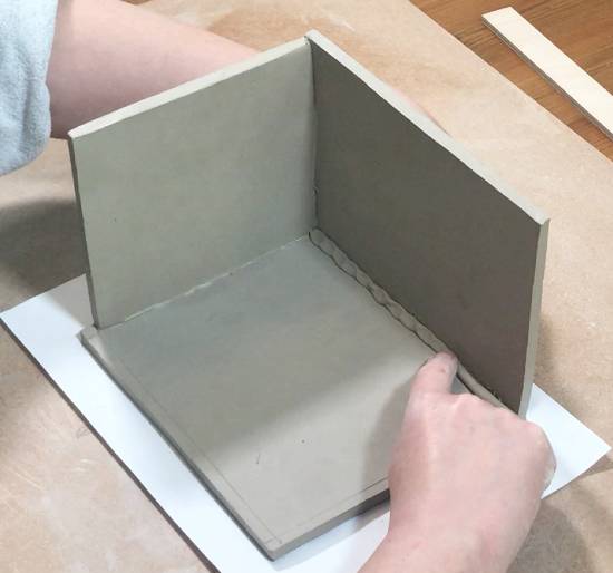 Adding clay coil to ceramic slab box