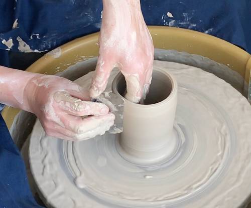 Metal rib tool on pottery