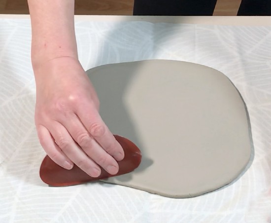 Smoothing the clay with a rib