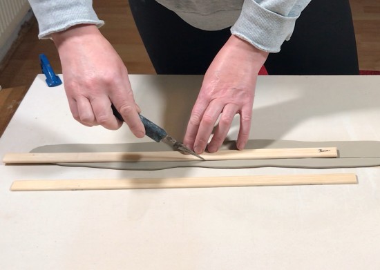 cutting out a strip of clay