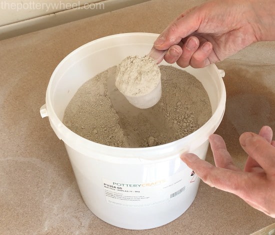 Powdered clay stored in a plastic container