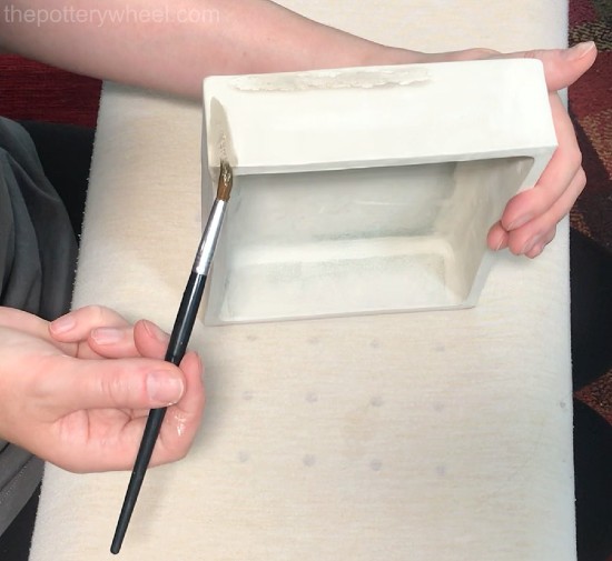 applying magic water with a paint brush