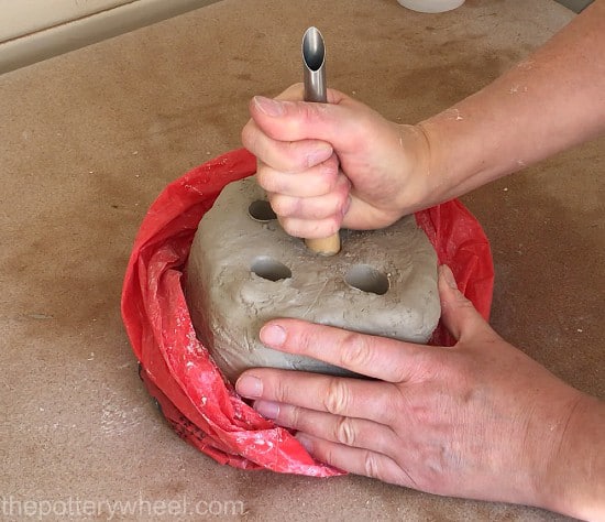 poking holes in pottery clay