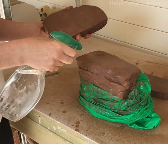 spraying the clay to store it in a moist state