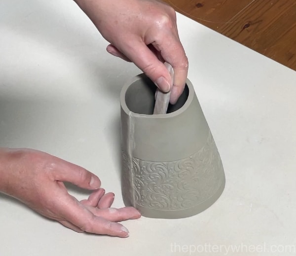 Blending the seam on the clay vase slab