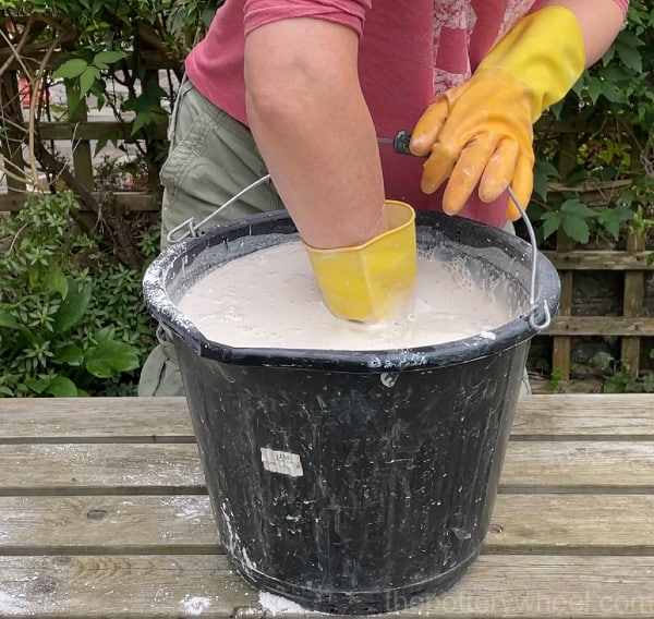 Stirring the mixture for plaster slab for drying clay