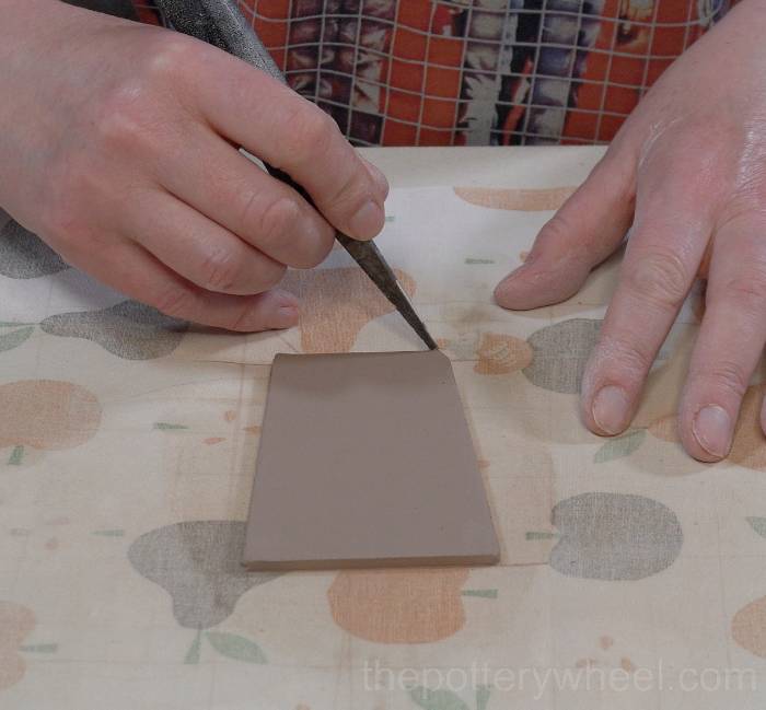 cutting out the lid of the slab pottery teapot
