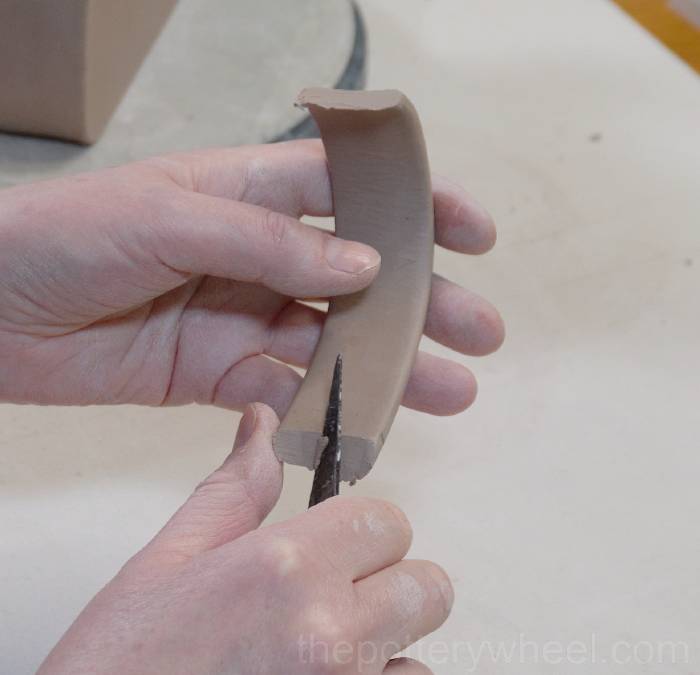 cutting the handle of the slab pottery teapot to length