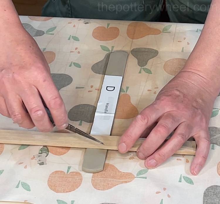 cutting out the slab pottery handle