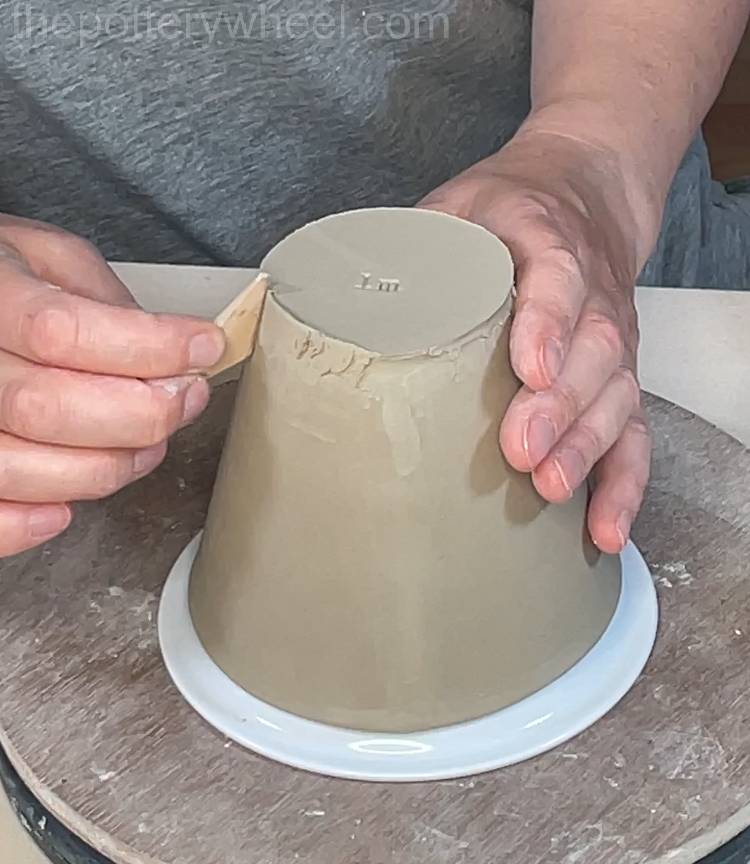 tidying up the base of the wide rimmed slab mug