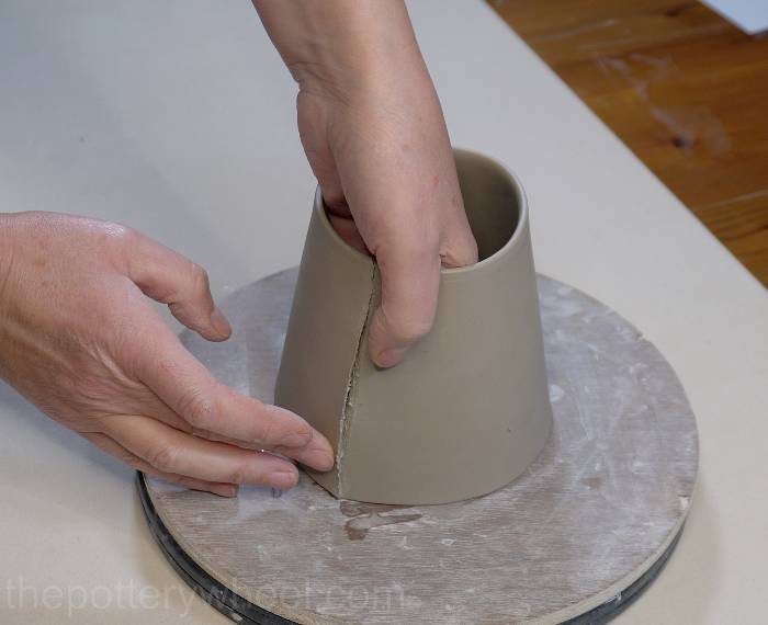 Pressing the edges of the clay slab together