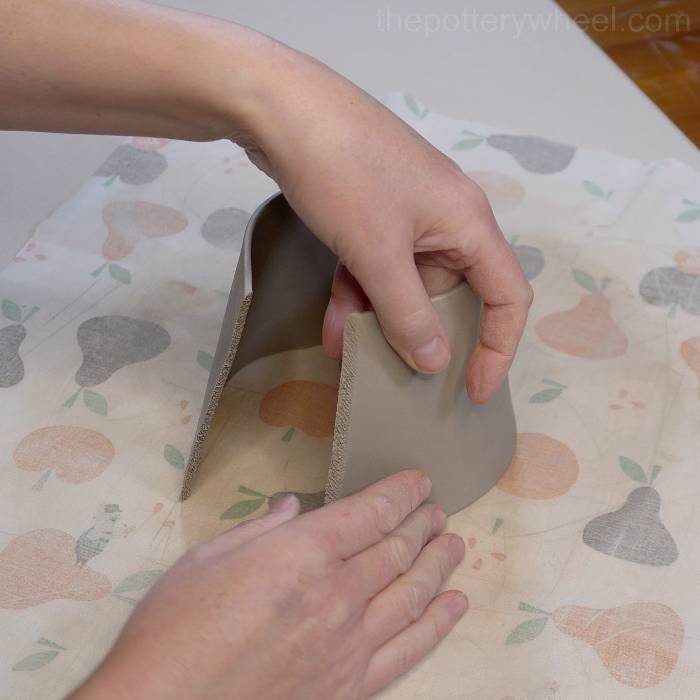 Shaping the clay slab to make the square bottomed slab mug