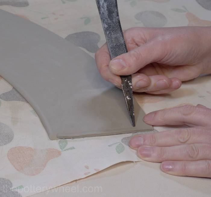 bevelling the edge of the clay slab