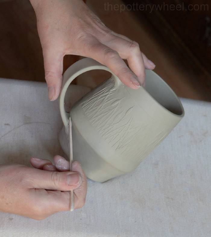 blending the handle on the bellied slab mug