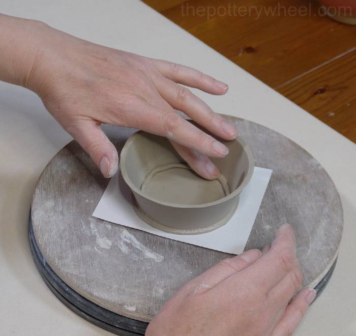 pressing the coil into the bottom of the mug