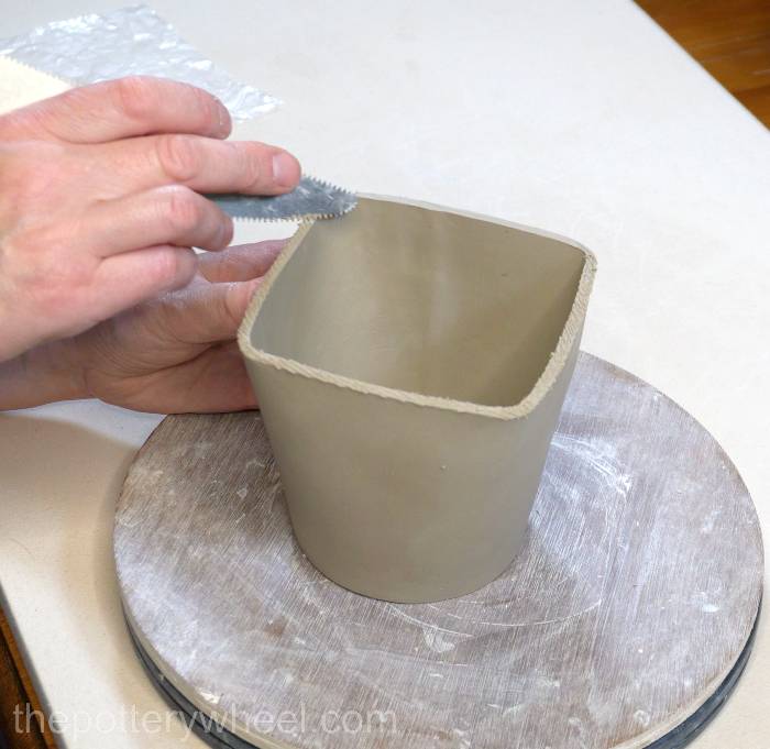 scoring the bottom edge of the mug