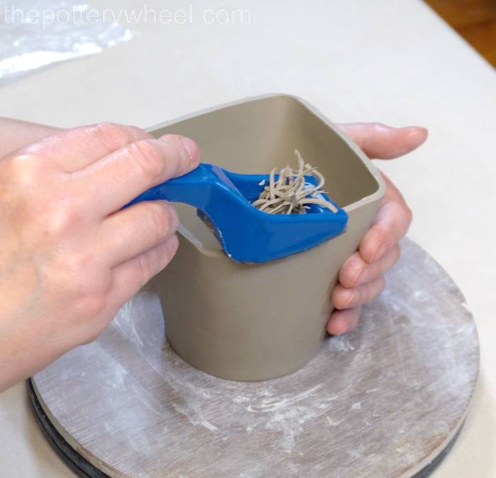 shredding the bottom edge of the mug