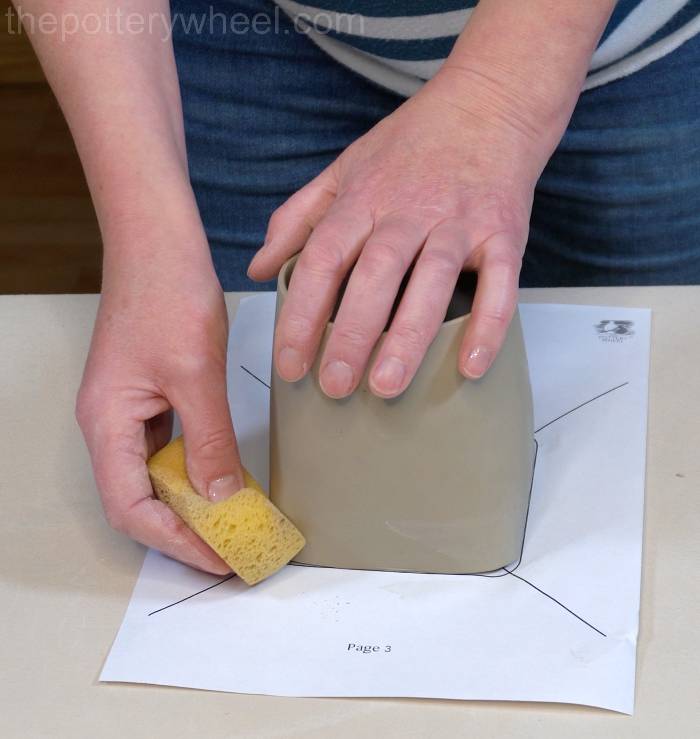 smoothing out the cracks on the bottom of the mug